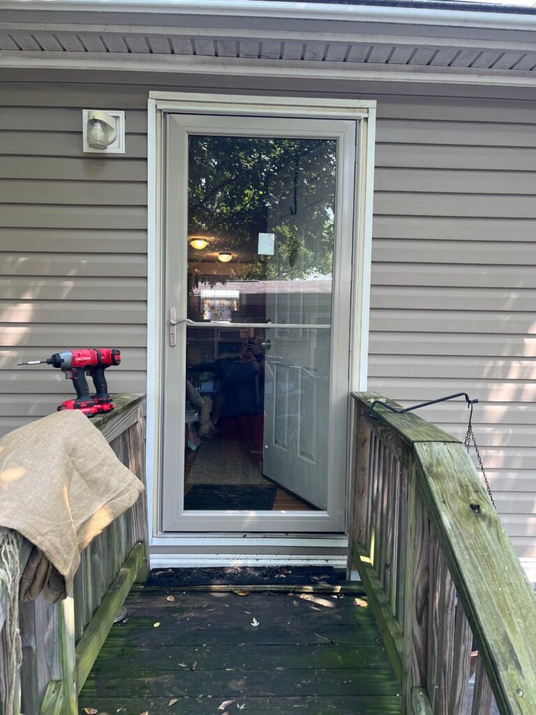 White storm door installed at a rear deck entry