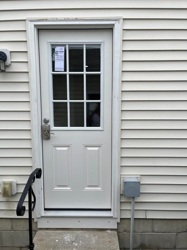 White JELD-WEN entry door with a nine-pane window, keypad handle and two lower panels